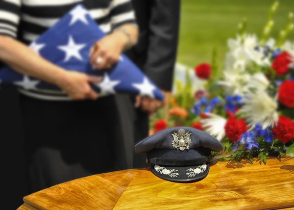 Lady holding folded flag at funeral